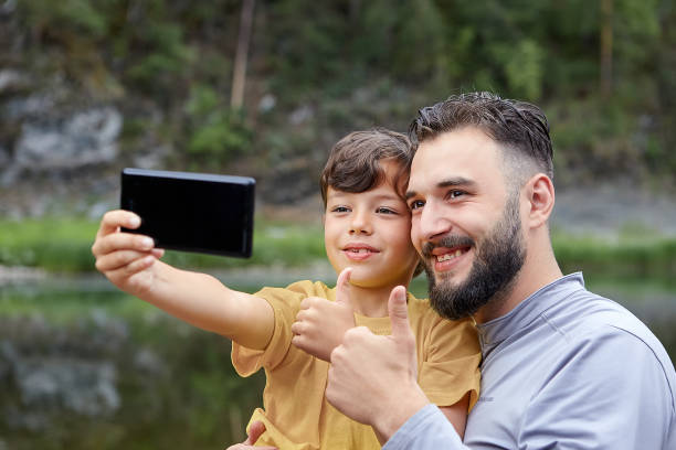 istock Family's selfie on river bank. 1166097608
