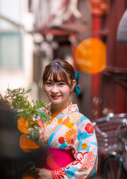 istock Young woman in yukata standing on narrow path 1166100968