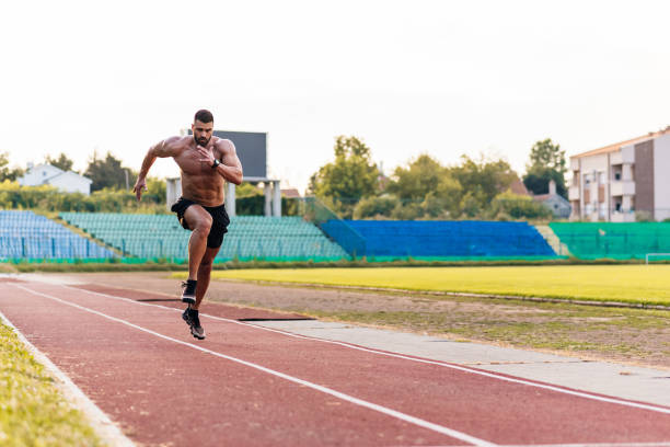 istock Young male athlete running on track 1166101903