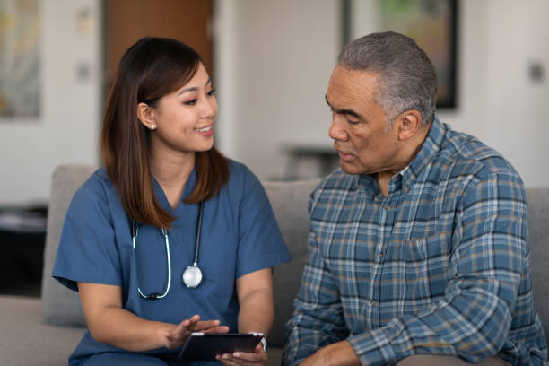 istock Young doctor with elderly patient 1166110823