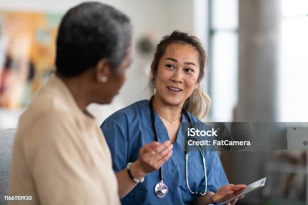 Doctor And Patient Having A Conversation Stock Photo - Download Image Now - Doctor, Patient, Nurse