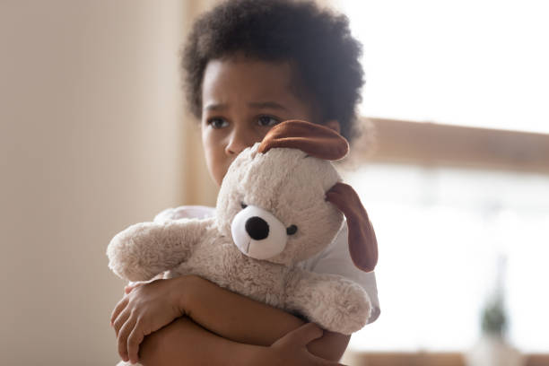 istock Hurt small biracial boy hold toy feeling lonely 1166110933