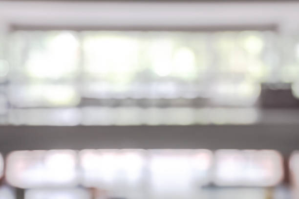 istock Office building lobby hall blur background or blurry school hallway corridor interior view looking toward empty corridor entrance, glass curtain wall and floor with exterior light illumination 1166111073