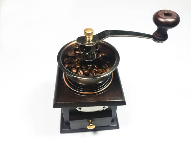 istock The wooden coffee grinder with coffee beans on white background 1166111582
