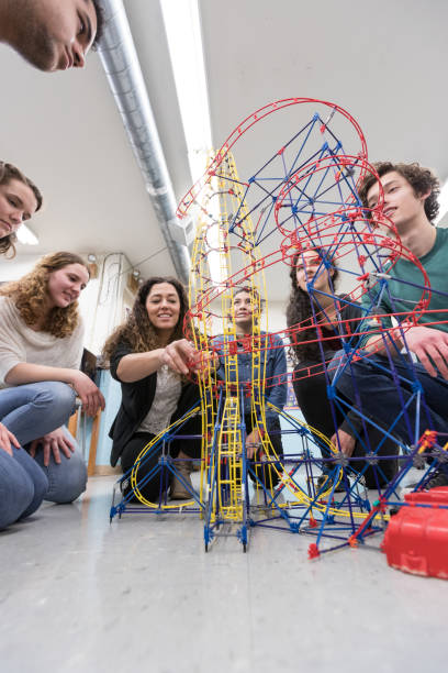 Ethnic art teacher shows her class a colorful example of sculpture