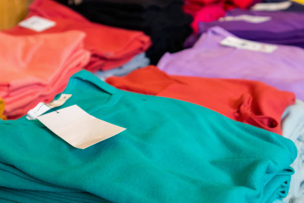 istock Blank white clothes tag on new shirt in store 1166116332