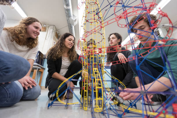 istock Ethnic art teacher shows her class a colorful example of sculpture 1166116342