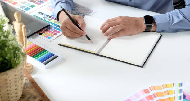 istock Graphic designer working with drawing tablet and colour swatches 1166124245