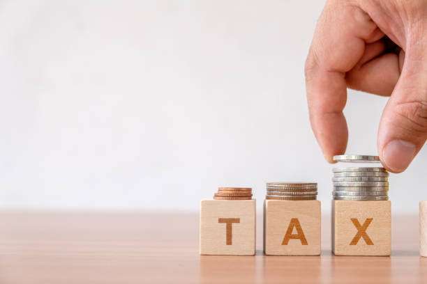 financial management taxes season Concept of tax and financial management taxes season in business. Hand putting coins stack step staircase on wooden cube block with  TAX word. TAX SERVICE stock pictures, royalty-free photos  images