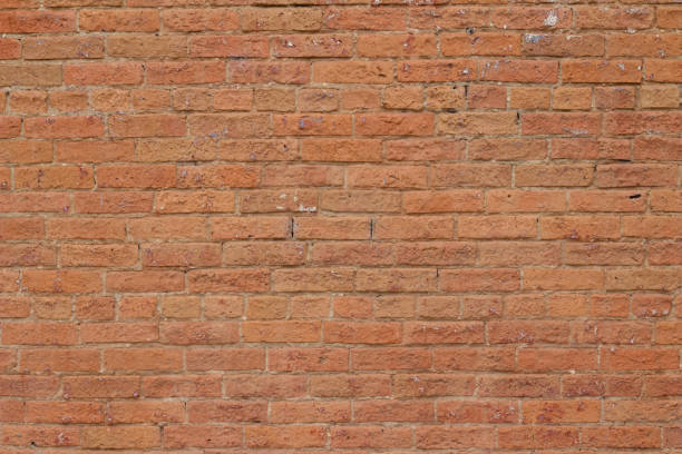 istock Antique reddish orange color brick wall background showing cracks and deterioration 1166126489