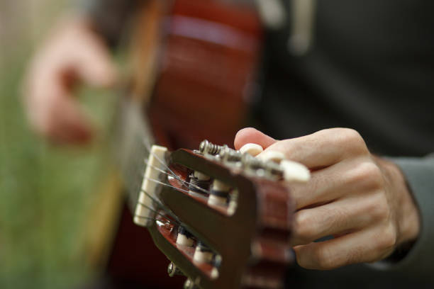istock hand tunes acoustic guitar chord 1166126497