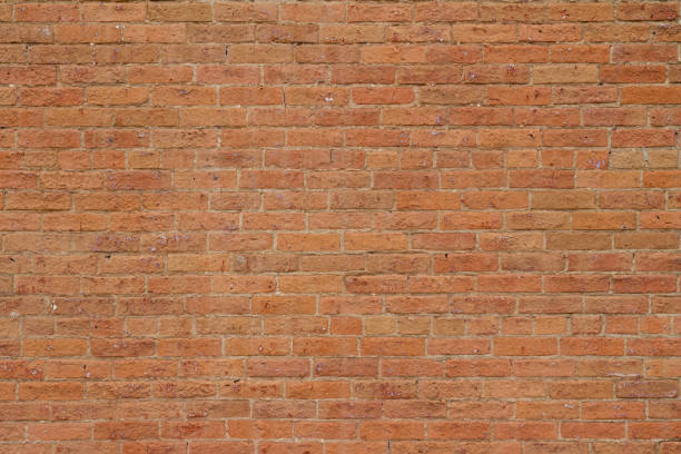 istock Antique reddish orange color brick wall background showing cracks and deterioration 1166126568