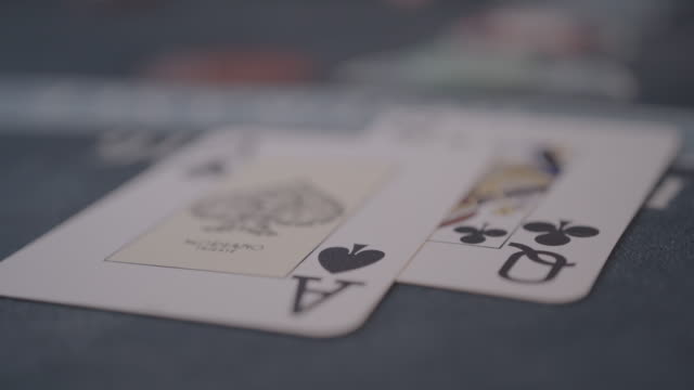 Detail of player's hands gambling in casino playing black jack