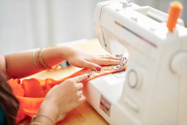 semstress making sari dress - seam needle textile industry thread imagens e fotografias de stock