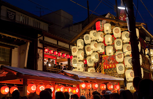 Kyoto, Japan - July 23, 2019: Night view of Yamahoko float with lanterns and people listening to music in Gion Festival