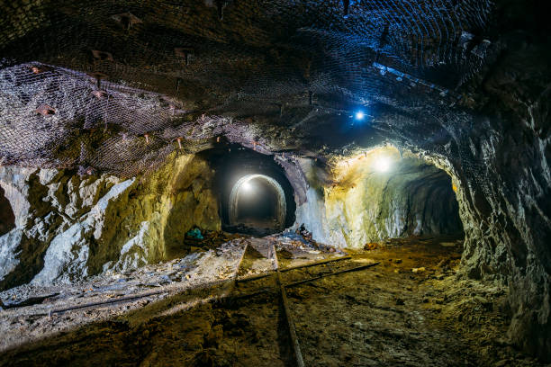 istock Dark dirty abandoned uranium mine with rusty remnants of railway 1166129964