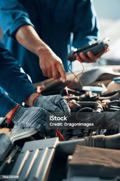 Mechanics Using Multimeter Stock Photo - Download Image Now - Car, Auto Repair Shop, Mechanic