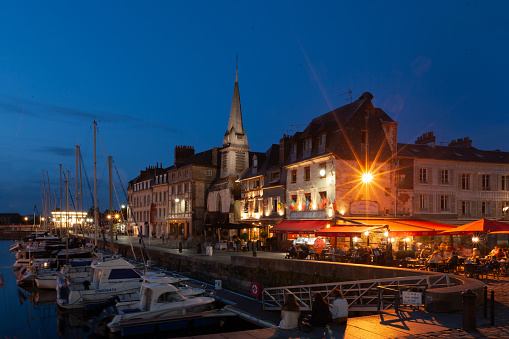 Honfleur, France - July 27, 2019: Old urban port at night. Honfleur is town in Calvados, France, it is especially known for its old port, painted many times by artists forming Honfleur school