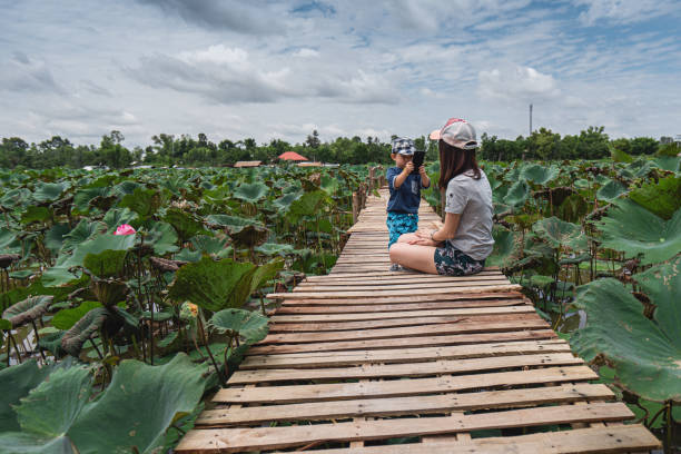 Mother and Son in Lotus Pond