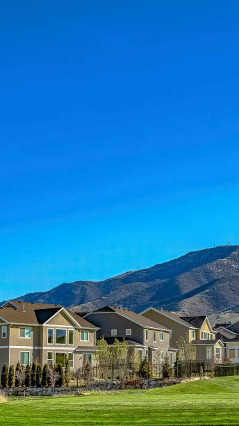 istock Vertical Charming homes and towering mountain under clear blue on a sunny day 1166132019