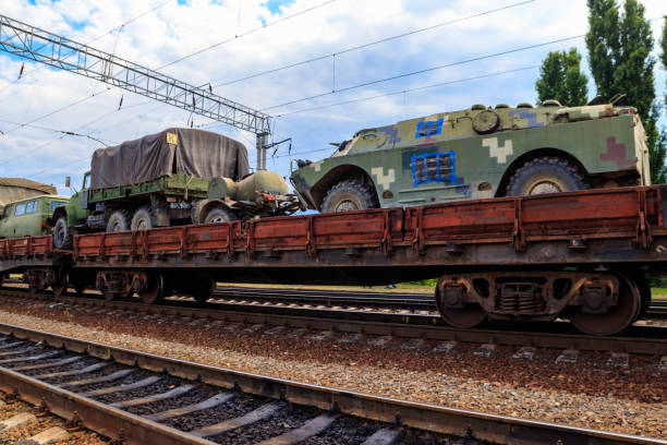 istock Cargo train carrying military vehicles on railway flat wagons 1166132020