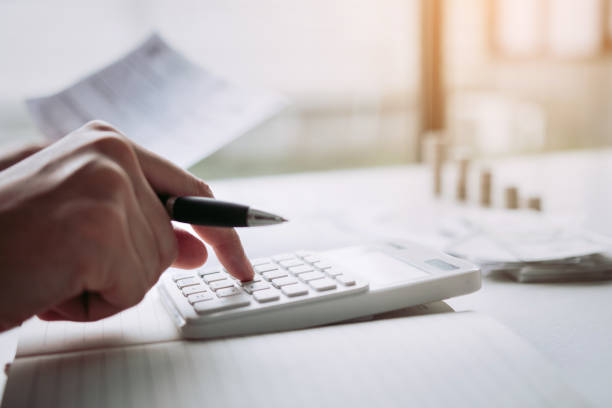 istock Man use calculators and documents that calculate expenses in the home office. 1166132847