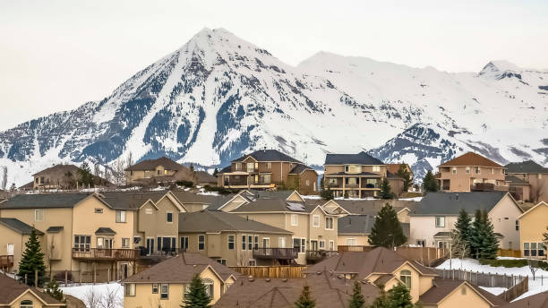 istock Panorama Hill homes with rugged snow covered mountain peak in the background 1166136035