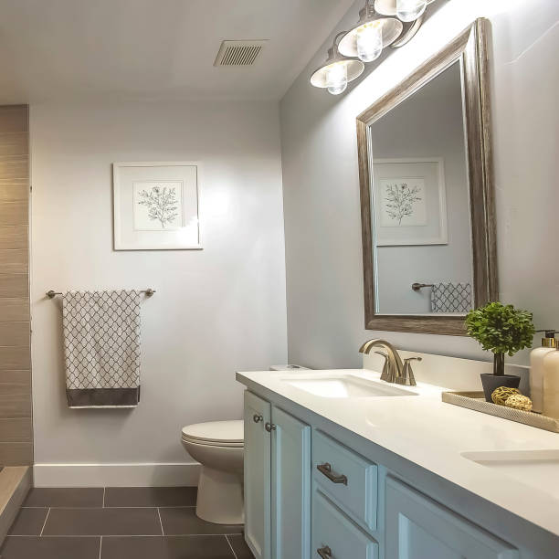 istock Square frame Bathroom interior with a bathtub in front of thee vanity area and mirror 1166136940
