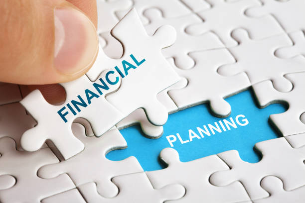 Hand holding piece of puzzle with words Financial Planning. Hand holding piece of puzzle with words Financial Planning. Business concept financial planning photos stock pictures, royalty-free photos & images
