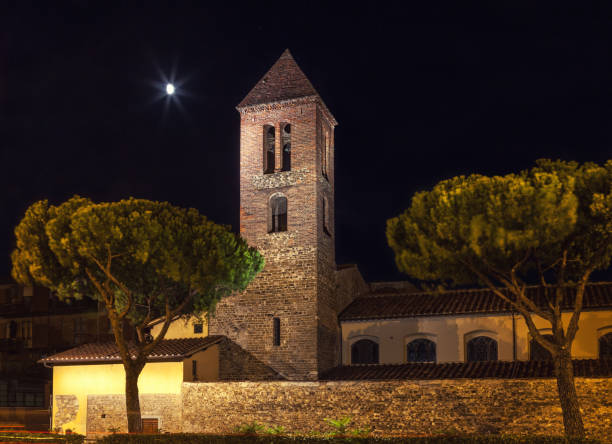 Stone bell tower at night. Ancient architecture in the moonlight, Florence Italy. Old historical building in the evening light.