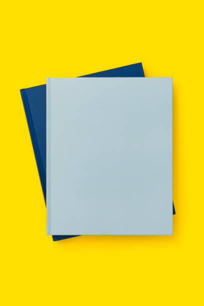 istock Blue books on yellow background 1166142880