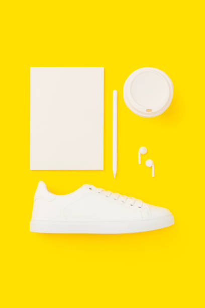 istock White personal accessories flat lay on yellow background 1166143230