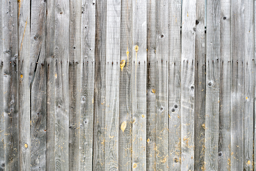 Background natural wooden boards. Texture of old unpainted wooden planks. Vertical arrangement of  wooden boards.