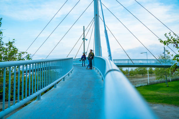 istock Young people walking on an elevated walkway with their longboards 1166144497