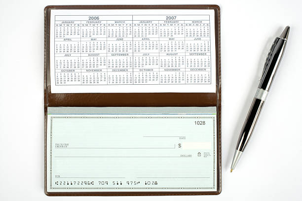 Open Check book with pen stock photo