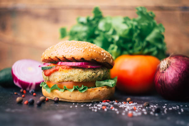 istock Vegetarian burger (home made burger) with chickpea cutlet and vegetables. Veg concept. Copy space. 1166146015
