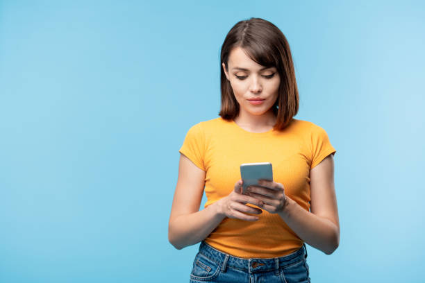 istock Pretty young serious woman scrolling in smartphone 1166147917