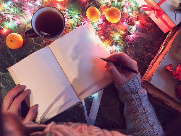 istock man with a blank book in his hands for the New Year's table with decorations 1166148766