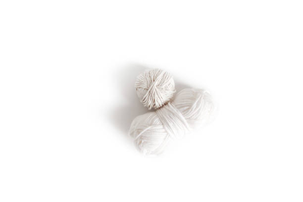Balls of white yarn. Isolated skein of wool boho logo. Space for text stock photo
