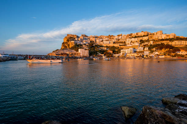 istock Setting sun lit city over the sea 1166149109