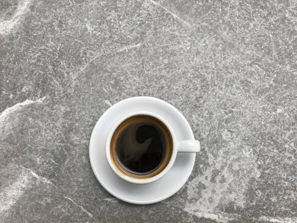 istock hot black coffee in white cup put in the middle of granite stone table 1166149159