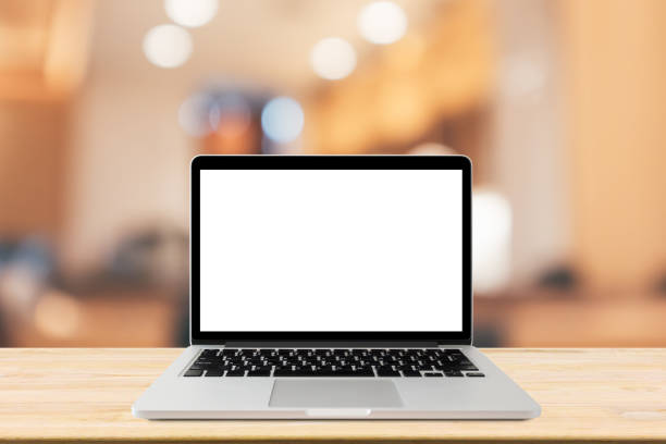 istock Blank screen laptop computer on wood table top with blur cafe restaurant with abstract bokeh light defocused background 1166149348