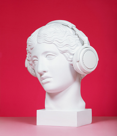 Plaster head model (mass produced replica of Head of an Amazon) wearing headphones