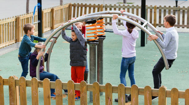 istock Boy in elementary school age riding toy on children's playground 1166155317
