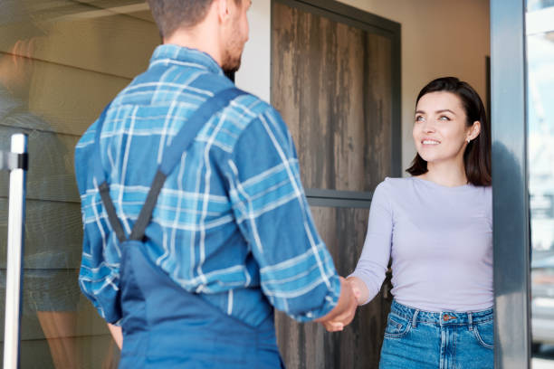 istock Happy young client of maintenance service shaking hand of technician 1166155366