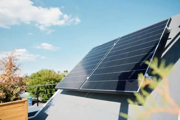 Photo of Large solar panels on rooftop of modern comfortable house or cottage