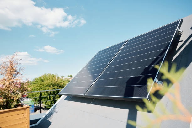 large solar panels on rooftop of modern comfortable house or cottage - solar panels house imagens e fotografias de stock