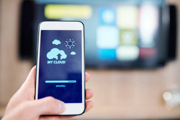 istock Smartphone with cloud and sun icons and uploading line on display 1166155394