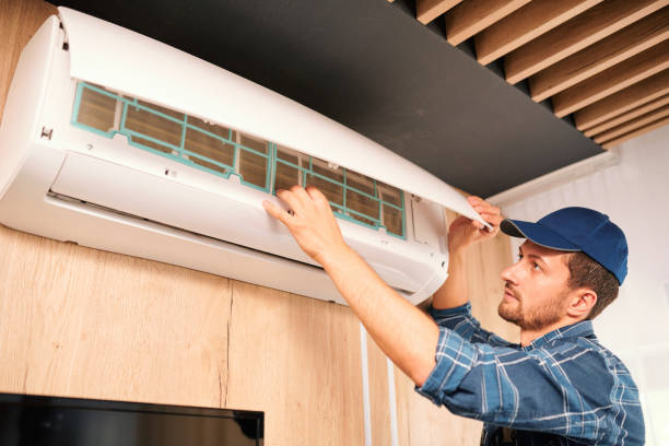 istock Young technician opening lid of air conditioner to check what is wrong with it 1166155395