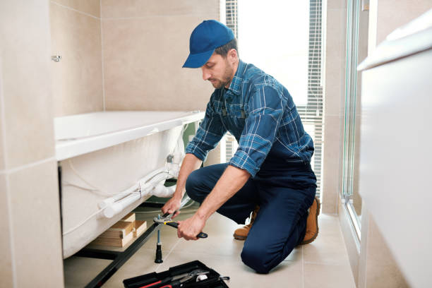 istock Young plumber or technician preparing detail for bathtub installation 1166155396